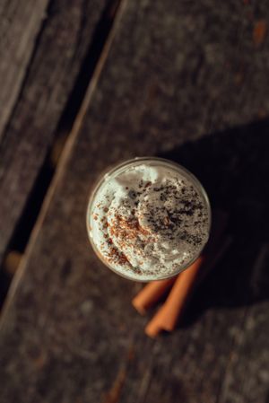 Cinnamon near coffee on table