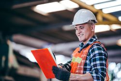 Smiling construction man with clipboard