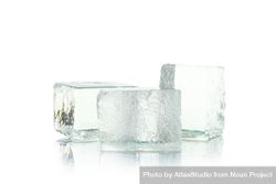 Three square ice cubes stacked in bright room 5pwZw0