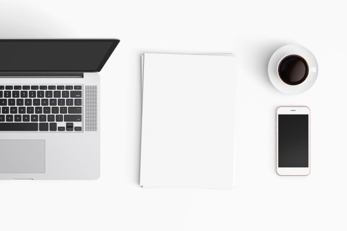 Modern workspace with coffee cup, smartphone, paper, notebook, tablet and laptop copy space