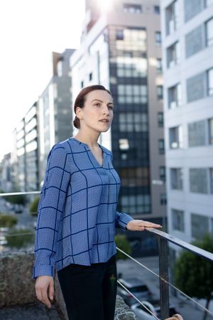 Smiling businesswoman standing on balcony