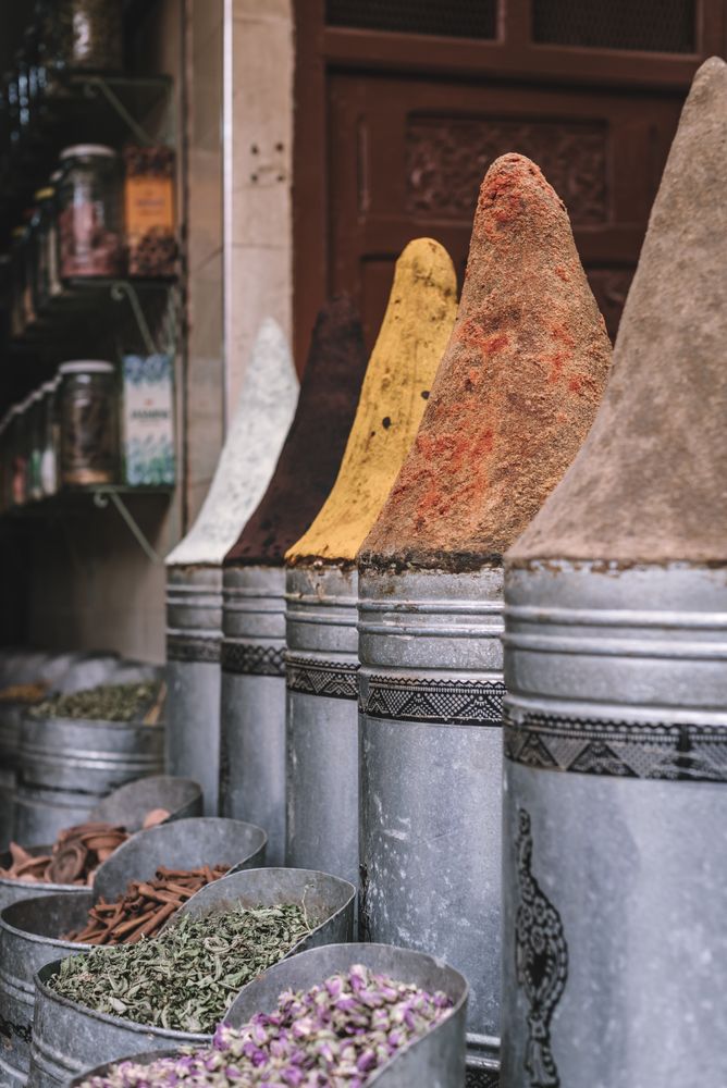 Metal jars with spices on market