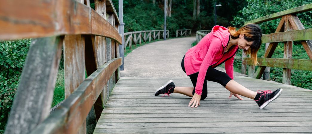 Athlete woman doing leg stretch