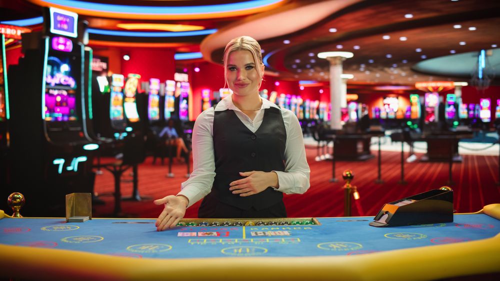 Portrait of a Female Croupier Looking at the Camera and Sharing the Results of a Baccarat Card Game.
