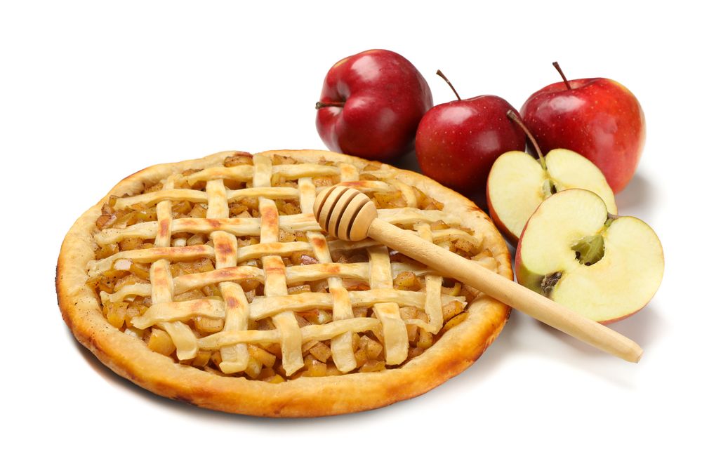 Tasty apple pie, apples and dipper isolated on blank background