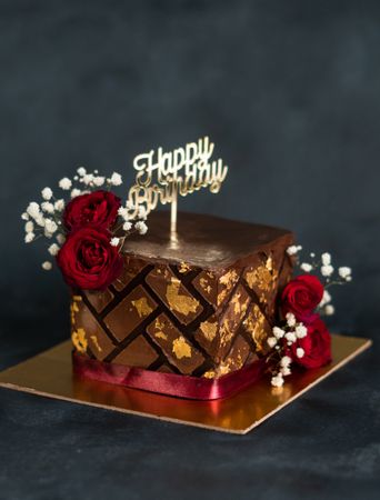 Square chocolate cake with happy birthday sign