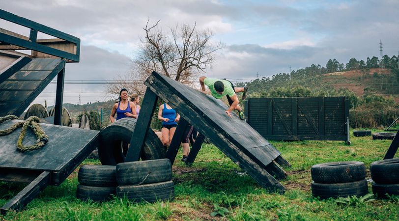 Participants in obstacle course climbing wall