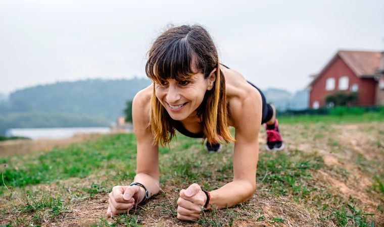 Female athlete training doing plank