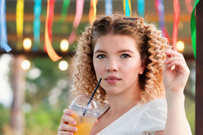 Woman with drink outdoors