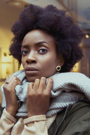 Portrait of young woman wearing gray scarf