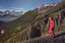 Boy walking on slope of mountain