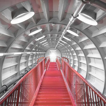 Red stairs in light tunnel