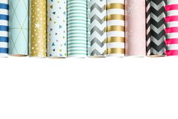 Rolls of festive wrapping paper on blank background. Space for text
