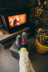 Legs resting being warmed by the fireplace