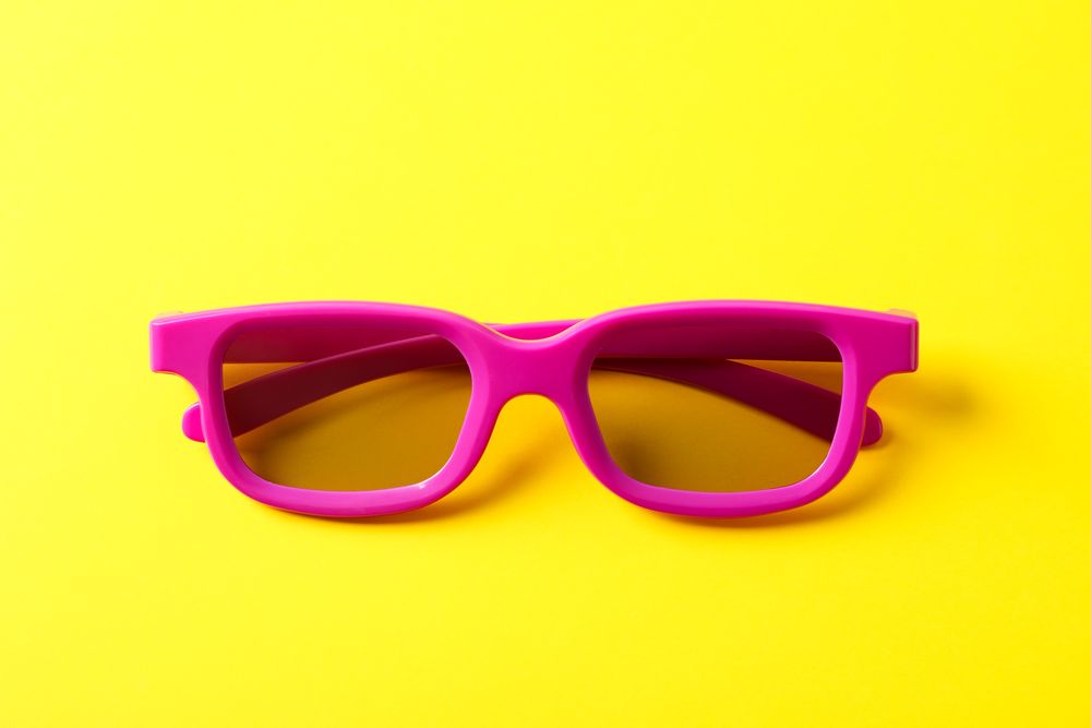 3d glasses on yellow background, close up