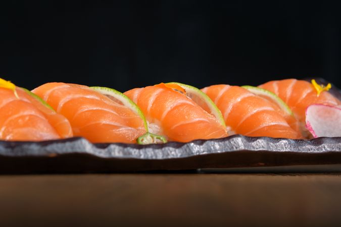 Appetizing nigiri sushi with salmon on tray