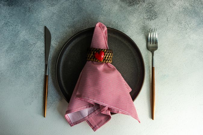St Valentine day table setting with red napkin, and heart