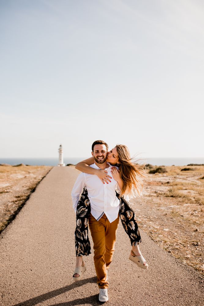 Happy lovers having fun on path from sea
