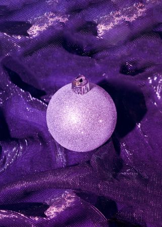 Christmas bauble decoration on purple cloth