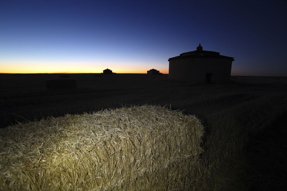 Aged house in rural countryside under starry sky