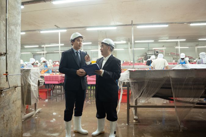 Entrepreneur inspecting at food processing in manufacturing line production.