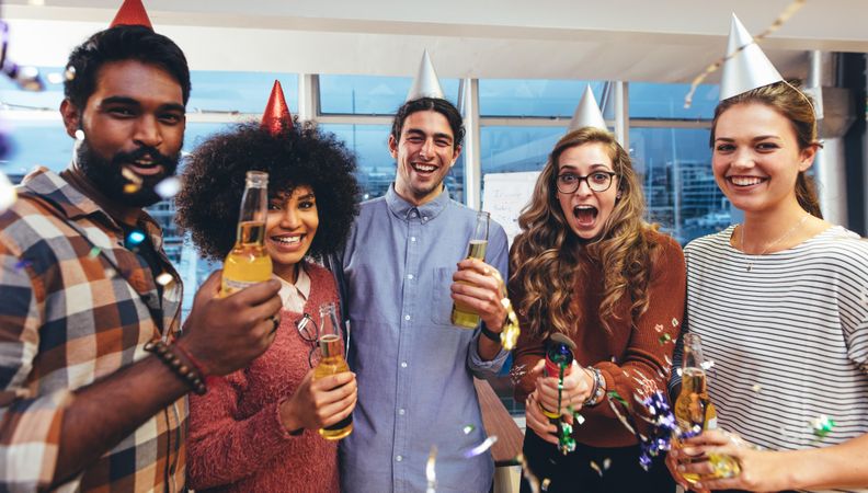 Coworkers having fun at a party in office to celebrate success