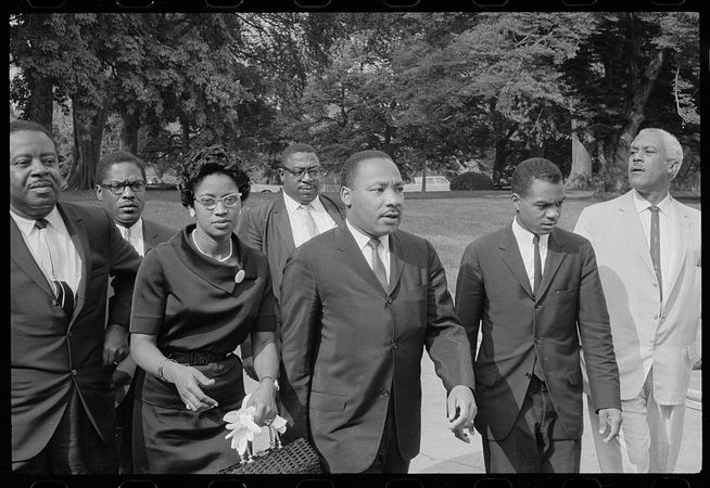 Martin Luther King and other civil rights activists arrive for meeting with President LBJ