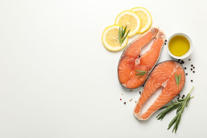 Composition with salmon meat and spices on plain background, top view