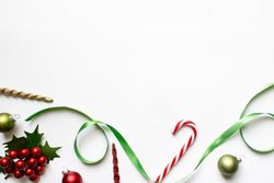 Christmas theme backdrop with red and green ornaments, ribbon, candy cane, and decoration.