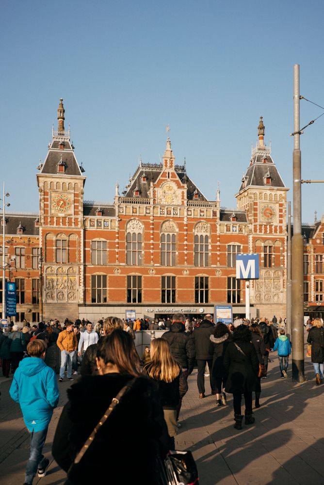 Backs of people approaching Amsterdam station