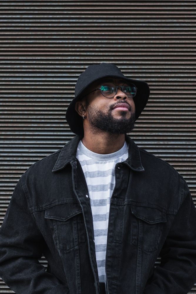 Black hipster man in hat looking away