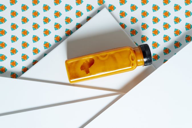 Mango and pumpkin smoothie bottle over retro textures