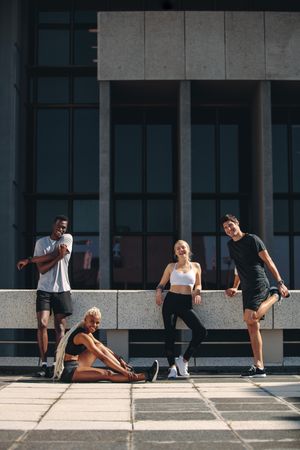 Group of runners relaxing after workout in the city