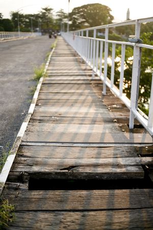 Hole in wooden pedestrian bridge, vertical