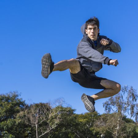 martial fighter practicing flying kicks