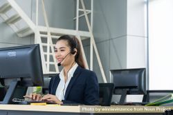 Woman speaking on headphones in call center 5rljnb