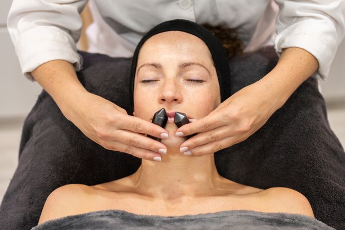 Woman having relaxing facial with chin massage