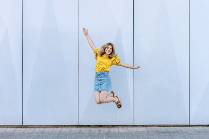 Young cheerful woman jumping