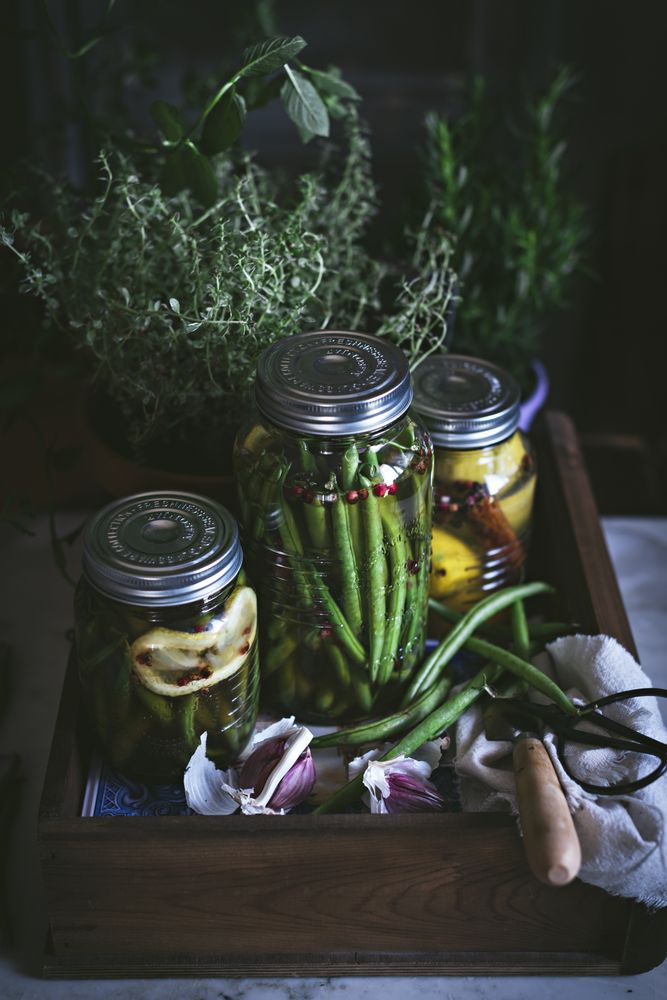 Fresh green vegetables with fruits and glass jars