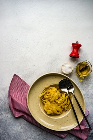Plain pasta with oil & salt on counter with copy space