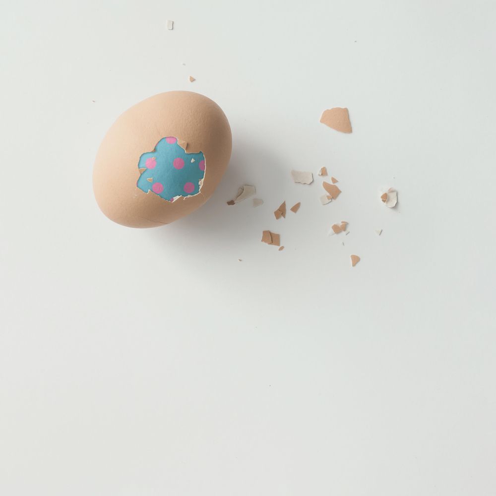 Peeled egg with double blue shell on light  background