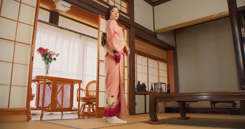 Female Standing in a Room at Home with Traditional Interior.