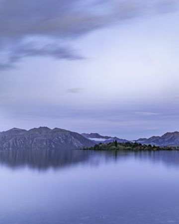 Landscape shot of calm lake with mountains in the background