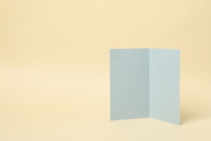 Light gray cardboard on beige background, space for text