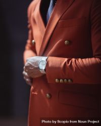 Cropped image of man in red suit wearing analog watch 5lKGa0