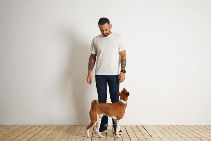 Casual, tattooed man with dog