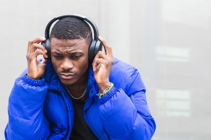 Black man listening to music in city