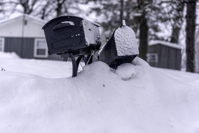 Mailboxes atop a snowy pile