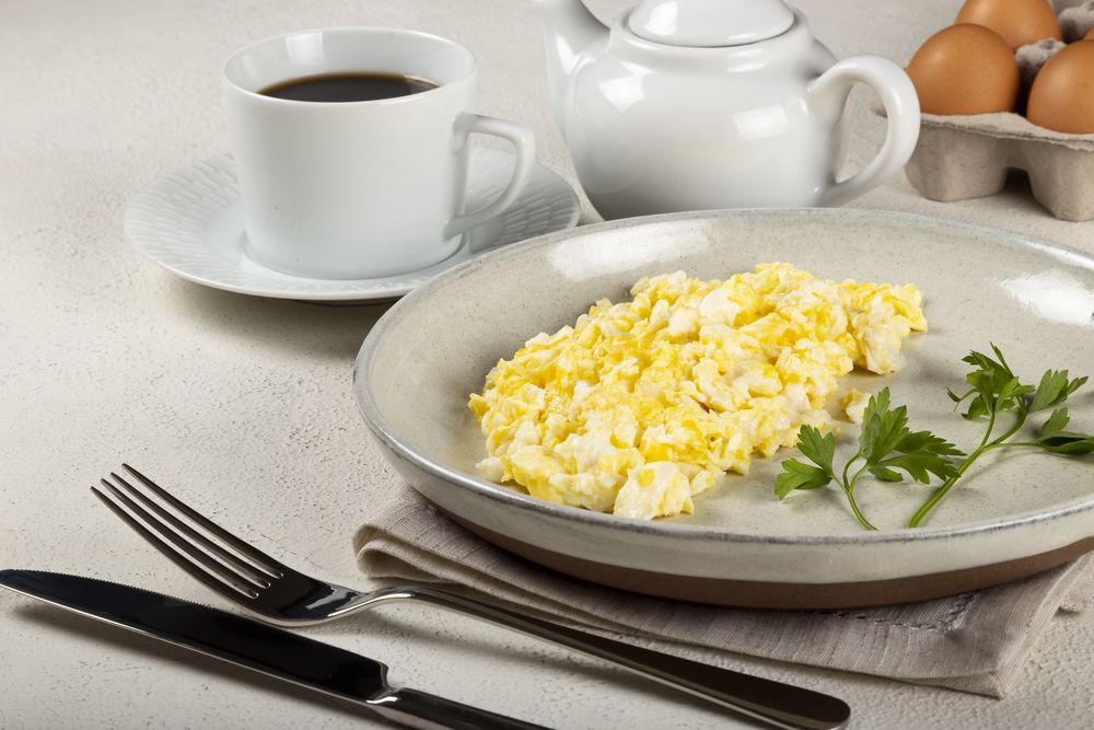 Breakfast with scrambled eggs on the table.