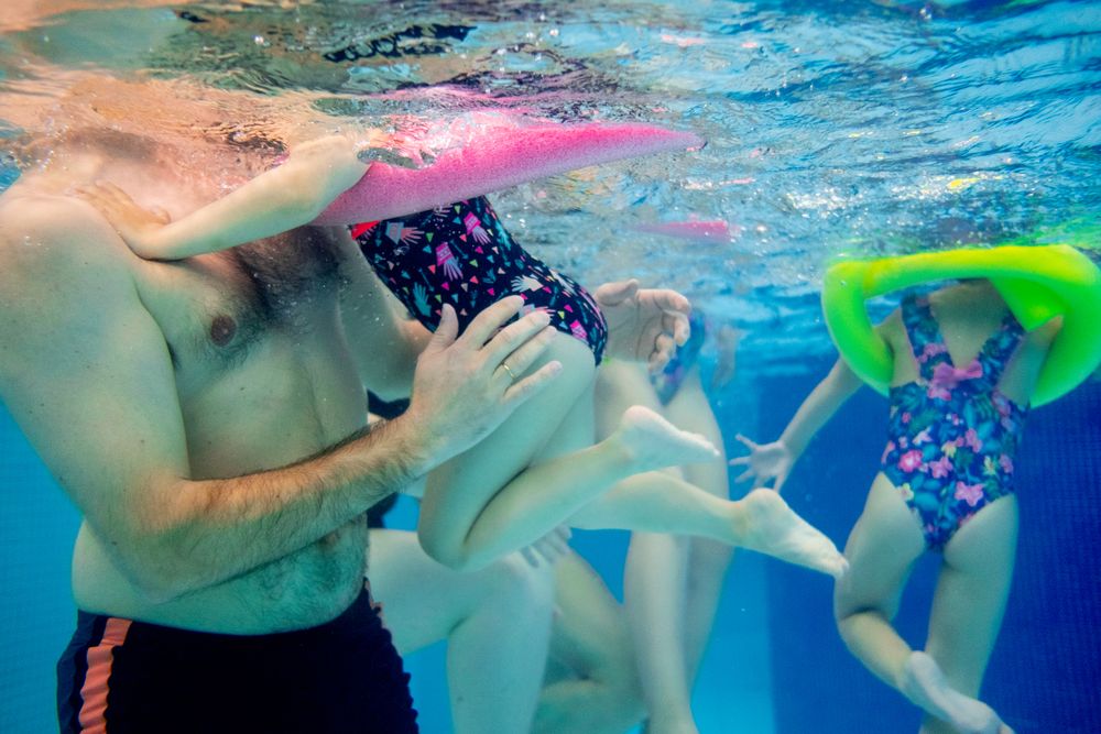 underwater People swimming in pool